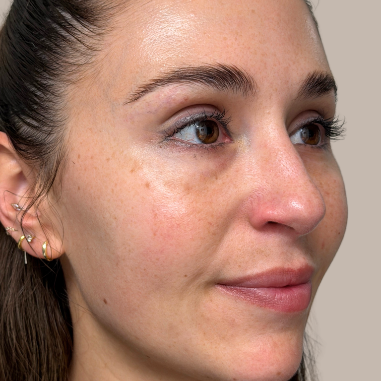 Close-up of a woman's face with a neutral background