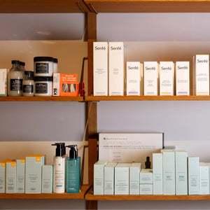 Shelves with various skincare products and boxes on a neutral background