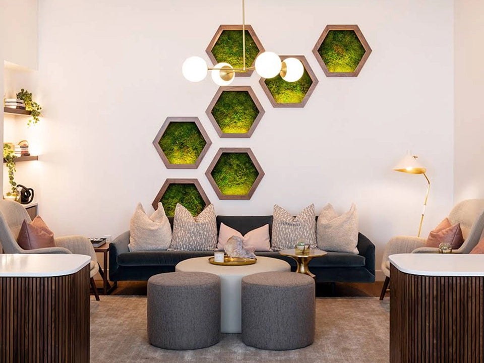 Modern living room with hexagonal green wall art and gray furniture.