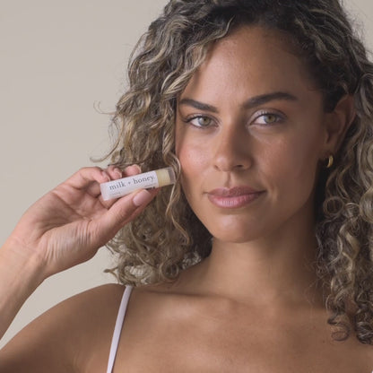 Woman holding milk + honey Lip Balm